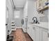 Laundry room with washer, dryer, wash sink, ample storage and dark floors at 602 Sea Vista Ln., North Myrtle Beach, SC 29582