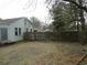 Fenced yard with partial view of the side of the house with siding at 606 Dawson St., Georgetown, SC 29440