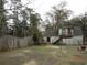 Large backyard features a combination of grassy areas, wooden fence and access to the exterior stairs at 606 Dawson St., Georgetown, SC 29440