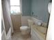 Cozy bathroom features a toilet, vanity, and tiled shower with a window at 606 Dawson St., Georgetown, SC 29440