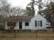 Charming single-story home with light blue siding, dark shutters, and mature trees in the front yard at 606 Dawson St., Georgetown, SC 29440