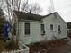 Exterior view of the house showing the windows and light green siding on a cloudy day at 606 Dawson St., Georgetown, SC 29440