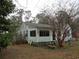 Quaint cottage-style home featuring a screened porch and surrounded by mature trees at 606 Dawson St., Georgetown, SC 29440