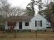 Charming single story home featuring light blue siding, black shutters, and a cozy front yard with mature tree at 606 Dawson St., Georgetown, SC 29440