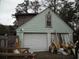 View of garage door and the back side of the house with light green siding at 606 Dawson St., Georgetown, SC 29440