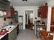 Functional kitchen featuring vintage cabinets and tile flooring with a view of the entry and stairs at 606 Dawson St., Georgetown, SC 29440
