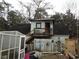 View of the home's rear featuring a small porch, stairs, a fenced yard, and an outbuilding at 606 Dawson St., Georgetown, SC 29440