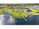 Community amenities with a tennis court, playground, and a picturesque pond with a pier at 641 Indigo Bay Circle, Myrtle Beach, SC 29579