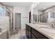 The bathroom showcases double vanities with granite counters, a glass shower, and access to a walk-in closet at 641 Indigo Bay Circle, Myrtle Beach, SC 29579