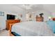 Bedroom with plush carpet, ceiling fan, natural light, wooden furniture, and a television at 641 Indigo Bay Circle, Myrtle Beach, SC 29579