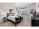 Cozy bedroom with neutral walls, a dark bed frame, and a window offering natural light at 641 Indigo Bay Circle, Myrtle Beach, SC 29579