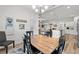 Open dining area featuring a rustic wooden table, a stylish chandelier, and a seamless connection to the living room at 641 Indigo Bay Circle, Myrtle Beach, SC 29579