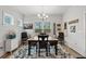 Bright dining room featuring a rustic wooden table, a stylish chandelier, and tasteful farmhouse decor at 641 Indigo Bay Circle, Myrtle Beach, SC 29579