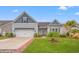 Charming home featuring a well-manicured lawn, a pergola over the garage, and delightful landscaping with palm trees at 641 Indigo Bay Circle, Myrtle Beach, SC 29579