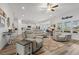 Bright living room with hardwood floors, plush furniture, a ceiling fan, and an open layout into the kitchen at 641 Indigo Bay Circle, Myrtle Beach, SC 29579