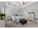 Bright main bedroom showcases a four-poster bed, neutral walls, and tasteful decor, creating a serene retreat at 641 Indigo Bay Circle, Myrtle Beach, SC 29579