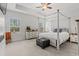 Spacious main bedroom features a four-poster bed, neutral tones, and natural light from the large window at 641 Indigo Bay Circle, Myrtle Beach, SC 29579