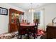 Formal dining room with hardwood floors, detailed rug, and custom wood china cabinet with a view to the outside at 6494 Royal Pine Dr., Myrtle Beach, SC 29588