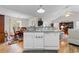 Open-concept kitchen area featuring laminate countertops, white cabinets, modern appliances, and a dining area at 6494 Royal Pine Dr., Myrtle Beach, SC 29588