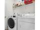 Convenient laundry room equipped with washer, dryer, and shelving at 6494 Royal Pine Dr., Myrtle Beach, SC 29588