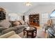 Inviting living room with hardwood floors, cozy seating, and a built-in bookcase providing ample storage space at 6494 Royal Pine Dr., Myrtle Beach, SC 29588