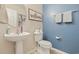 Bathroom featuring a pedestal sink, toilet, and fresh blue accent wall with decorative towels at 651 Riverward Dr. # 651, Myrtle Beach, SC 29588