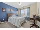 Well-lit bedroom featuring a bed with a blue striped comforter, desk, and charming football decor at 651 Riverward Dr. # 651, Myrtle Beach, SC 29588