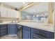 Kitchen with stainless steel dishwasher and navy blue cabinets below white countertops at 651 Riverward Dr. # 651, Myrtle Beach, SC 29588