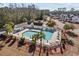 Aerial view of a fenced community pool and deck area with chairs, tables, and umbrellas at 651 Riverward Dr. # 651, Myrtle Beach, SC 29588