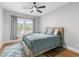 Serene bedroom with a cozy queen bed, a ceiling fan, and bright natural light at 8035 Arcady St. # B, Myrtle Beach, SC 29572