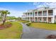 Two-story townhomes with double balconies sit along a scenic pathway, with waterfront views at 8035 Arcady St. # B, Myrtle Beach, SC 29572