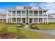 Beautiful two-story townhome with landscaped pathway and double balconies and a green and white paint scheme at 8035 Arcady St. # B, Myrtle Beach, SC 29572