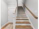 Well-lit foyer with hardwood floors and a staircase featuring white risers and a wood handrail at 8035 Arcady St. # B, Myrtle Beach, SC 29572