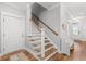 Bright foyer with hardwood floors and a staircase with white spindles and wooden handrail at 8035 Arcady St. # B, Myrtle Beach, SC 29572