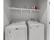 Functional laundry room with a white Maytag washer and dryer, and shelving for supplies at 8035 Arcady St. # B, Myrtle Beach, SC 29572