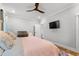 Bright main bedroom with a ceiling fan, TV, side table, and light colored walls at 8035 Arcady St. # B, Myrtle Beach, SC 29572