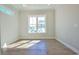 Bright bedroom with hardwood floors and a large window providing plenty of natural light at 8079 Laurel Ash Ave., Myrtle Beach, SC 29572