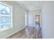 Well-lit room featuring hardwood floors, large windows, and neutral paint at 8079 Laurel Ash Ave., Myrtle Beach, SC 29572