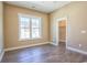 Cozy bedroom with hardwood floors, large windows, and an adjacent closet at 8079 Laurel Ash Ave., Myrtle Beach, SC 29572