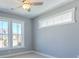 A carpeted bedroom with a ceiling fan and two windows at 8125 Living Tide Dr., Myrtle Beach, SC 29572