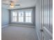 A carpeted bedroom with three windows at 8125 Living Tide Dr., Myrtle Beach, SC 29572