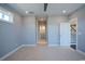 Spacious bedroom with neutral carpet, a window, and access to the hallway and stairs at 8125 Living Tide Dr., Myrtle Beach, SC 29572