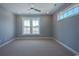 Cozy bedroom with neutral carpet, ceiling fan, and plenty of natural light from the ample windows at 8125 Living Tide Dr., Myrtle Beach, SC 29572