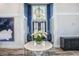 Elegant foyer with blue accent wall, stylish decor, and a beautiful white table with orchids at 8125 Living Tide Dr., Myrtle Beach, SC 29572