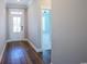 Inviting hallway with hardwood floors and doorway leading to a bedroom bathed in natural light at 8125 Living Tide Dr., Myrtle Beach, SC 29572