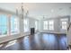 Spacious living room with hardwood floors, fireplace, many windows, neutral paint, and lots of natural light at 8125 Living Tide Dr., Myrtle Beach, SC 29572