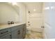 Modern bathroom with a combination tub/shower, neutral tile, and stylish vanity at 8156 Living Tide Dr., Myrtle Beach, SC 29572