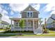 Charming two-story home featuring a welcoming front porch with white columns and manicured landscaping at 8156 Living Tide Dr., Myrtle Beach, SC 29572