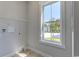 Practical laundry room with a window, tile floor, and wire shelving for convenient storage at 8156 Living Tide Dr., Myrtle Beach, SC 29572