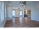 Spacious living area with hardwood floors, large windows and stainless steel appliances in the kitchen area at 8156 Living Tide Dr., Myrtle Beach, SC 29572